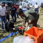 Image of group listening to demonstration with helicopter equipment