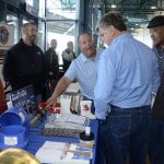 Men getting demonstration at a booth at the LFF Summit