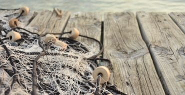 image of fishing net laying on a dock