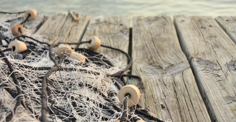 image of fishing net laying on a dock