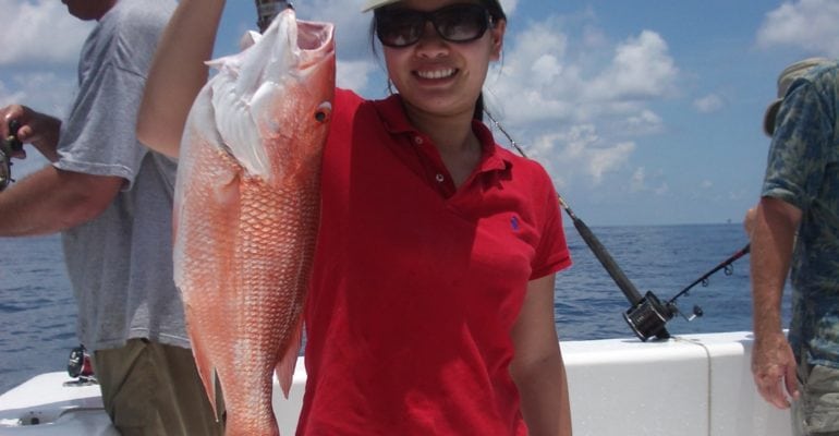 Thu Bui holding caught red snapper