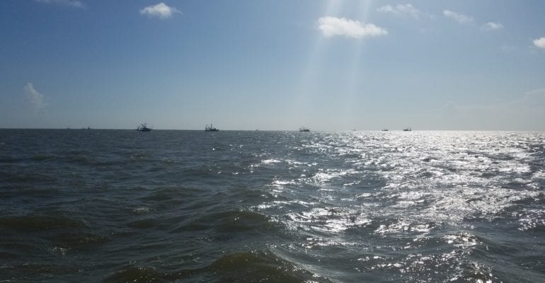 Gulf of Mexico with shrimp boats in far distance