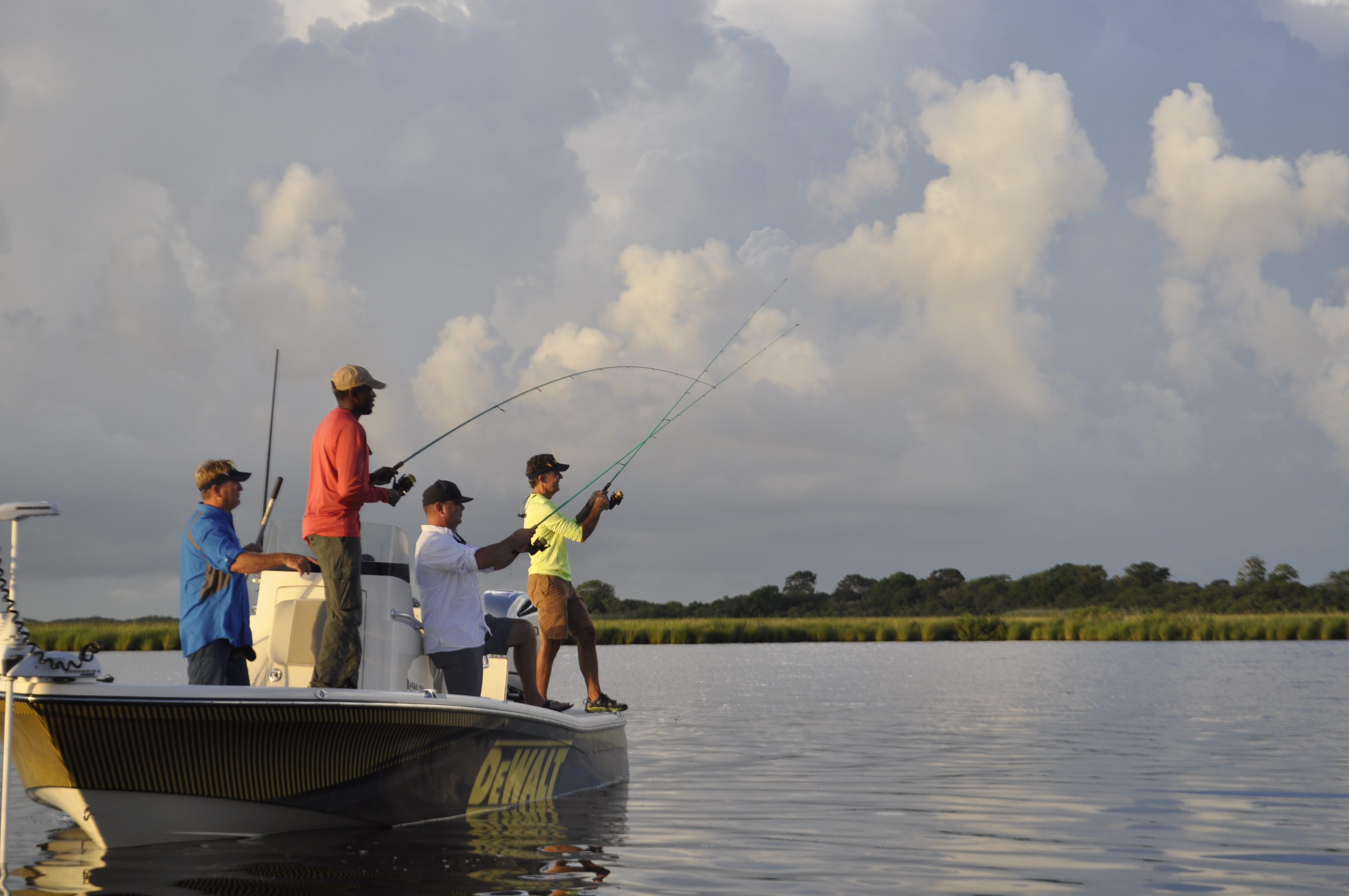 guys fishing boatside2 four men fishing from inshore charter boat