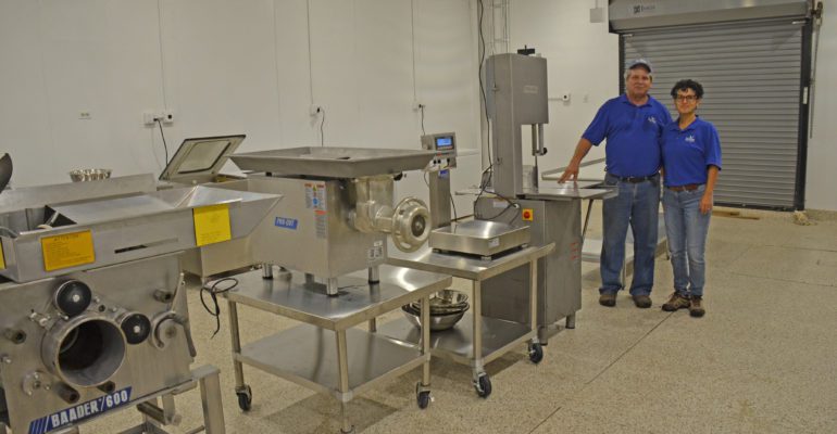 Interior photo of equipment and personnel at seafood processing demonstration lab